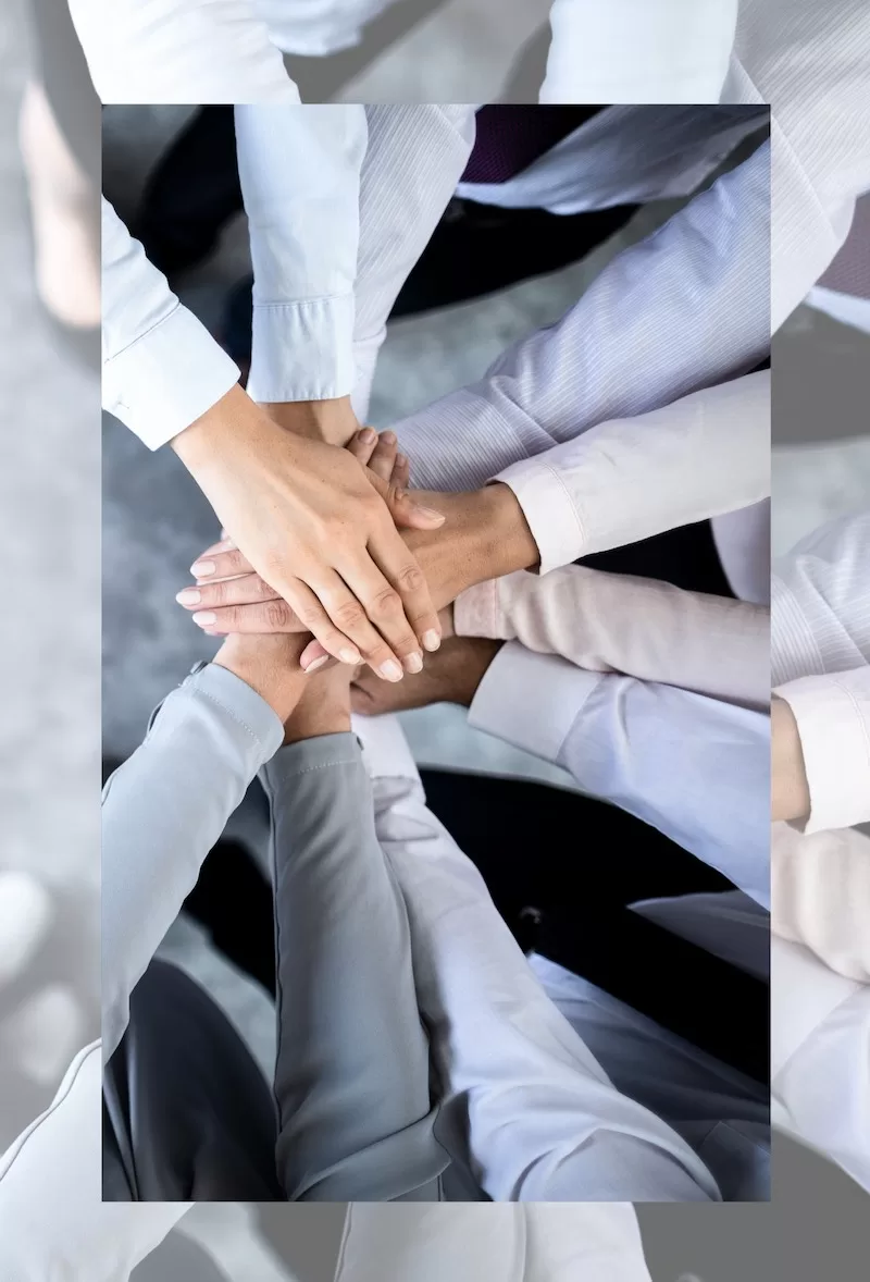 Day of Giving image Photograph showing hands joing together in a pact, symbolizing community and support.