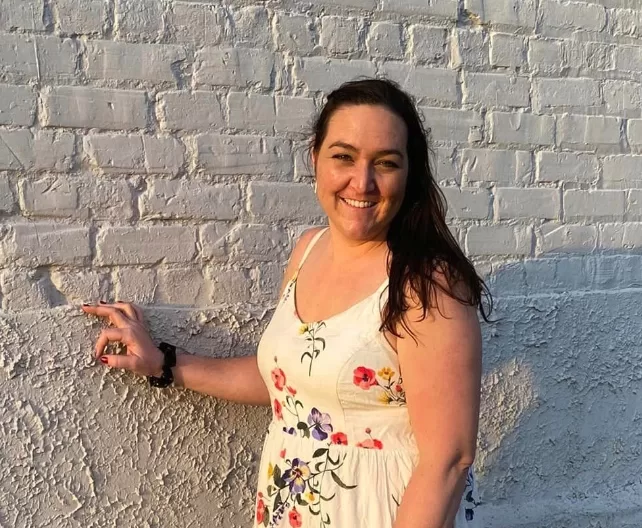 Image depicting VTVLC teacher, Sharon Rock, posing in front of a brick wall.